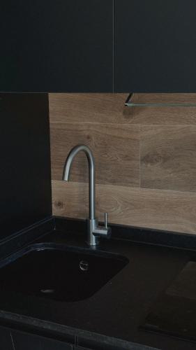 a kitchen with a sink and a wooden counter at El Balcón de Potes in Potes