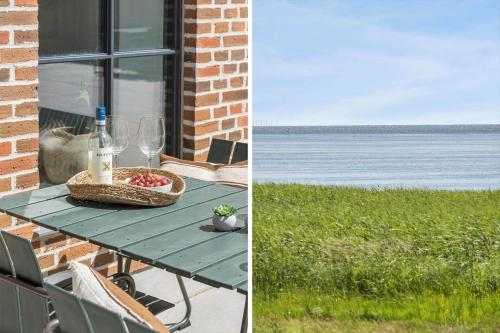a picnic table with a basket of food and wine glasses at 1174-Ringkobing-Jagtvej-34-C-lejl-5 in Ringkøbing