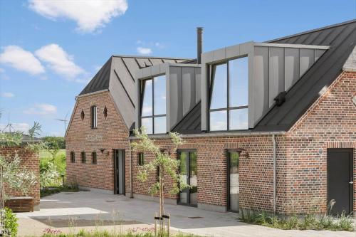 a brick house with a black roof at 1174-Ringkobing-Jagtvej-34-C-lejl-5 in Ringkøbing