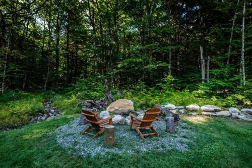 a group of chairs sitting around a fire pit at Dream Stratton Forest Cabin with Hot Tub and Fast WiFi in Stratton