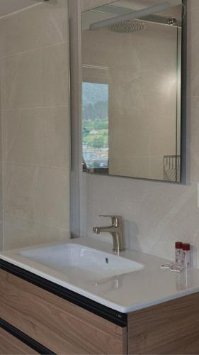 a bathroom with a sink and a mirror at El Balcón de Potes in Potes