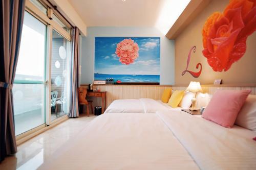 Cama o camas de una habitación en 夏之戀民宿 可包棟 近金城市區