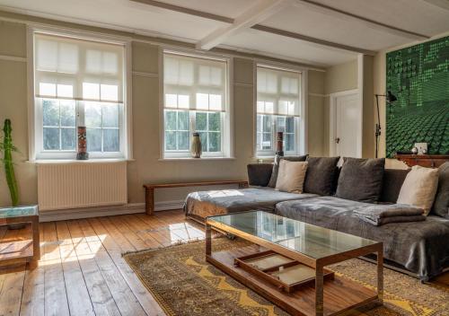 a living room with a couch and a coffee table at Country Home in Idyllic South Downs - Views, Free Parking for 7 cars, Play room, Steam room, Fire Pit and more in Kingston near Lewes