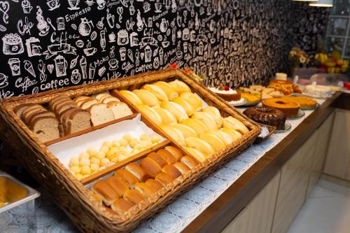a display of bread and pastries on a counter at Pousada Mirante da Prainha in Arraial do Cabo