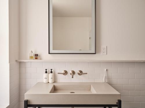 a white sink in a bathroom with a mirror at Mint House Washington DC - Downtown in Washington
