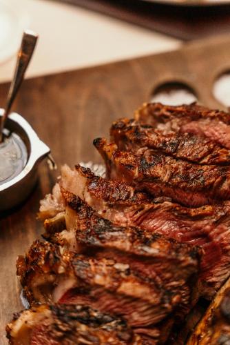 a pile of ribs on a cutting board with sauce at Four Seasons Hotel Buenos Aires in Buenos Aires