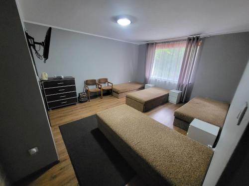 a small room with two beds and a window at Pokoje Gościnne Grzybowo in Grzybowo