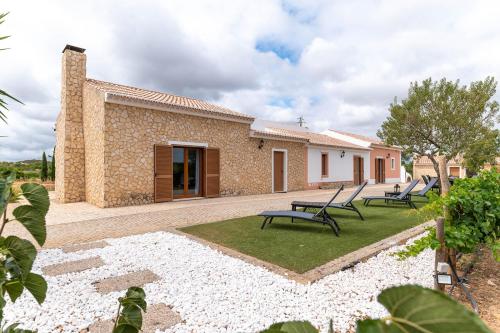a patio with benches in front of a building at Quinta da Amoreira in Barão de São Miguel