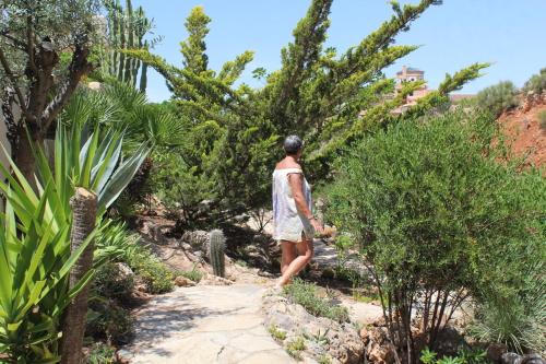 a man walking down a path through a garden at Casa Pia in Turre