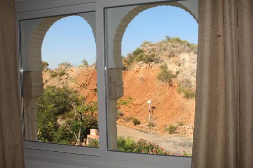an arched window with a view of a mountain at Casa Pia in Turre