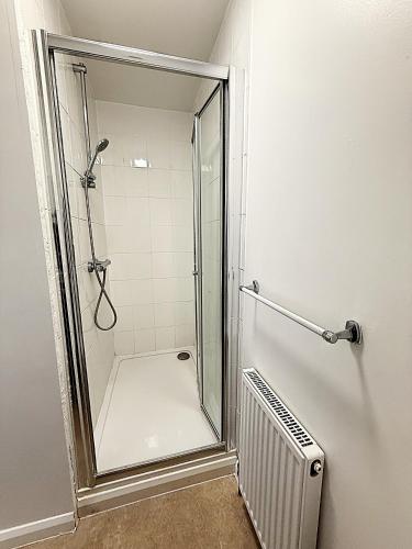 a shower with a glass door in a bathroom at Simplystay Lincoln Road in Skegness