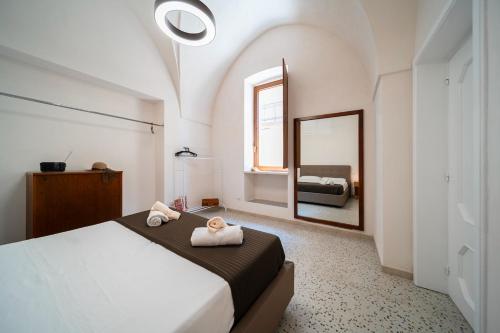 a bedroom with a large bed with a mirror at La Fontana Casaurea Apartment, Centro-AC in Villa Castelli