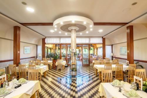 a dining room with white tables and chairs at Restoran Bosiljevo in Bosiljevo