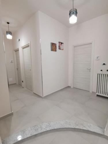 a large room with white walls and white doors at Angela's House in Alessandria
