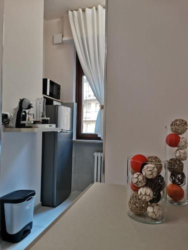 a kitchen with a table with a vase filled with eggs at Angela's House in Alessandria
