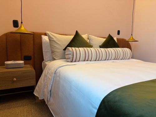 a bedroom with a large white bed with pillows at Veca Flats Centenario in Cali