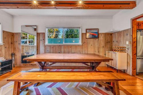 a dining room with a table and two benches at Tahoe City Gem Pet Friendly Yard Walk to Beach in Tahoe City