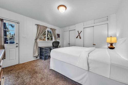 a white bedroom with a large white bed and a desk at Tahoe City Gem Pet Friendly Yard Walk to Beach in Tahoe City