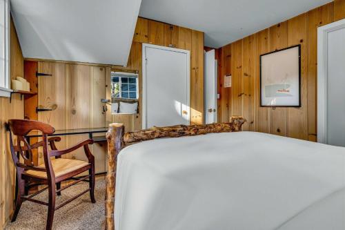 a bedroom with a large bed and a chair at Tahoe City Gem Pet Friendly Yard Walk to Beach in Tahoe City