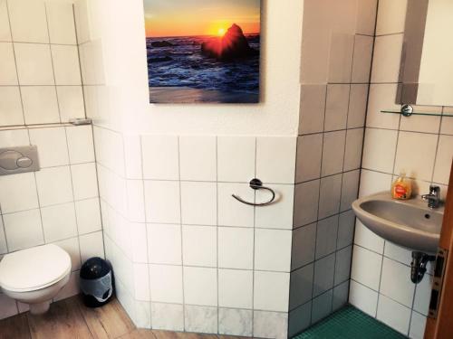 a bathroom with a toilet and a sink at Gästehaus Parkblick in Rust
