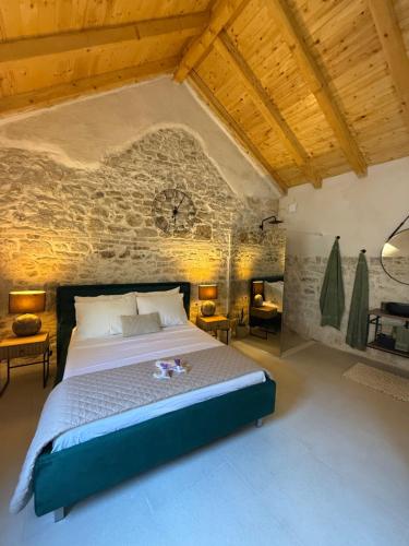 a bedroom with a bed with a clock on the wall at The Hideaway - Kastel Novi in Kaštela
