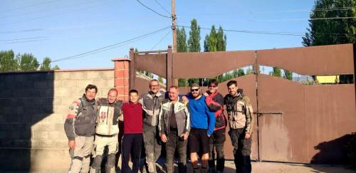 a group of people standing in front of a wall at Gulcha in Gultscha