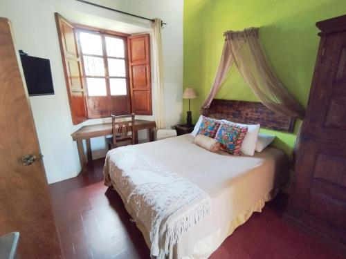 Ένα ή περισσότερα κρεβάτια σε δωμάτιο στο Hostal Antigüeño