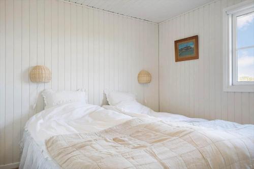 a white bed in a room with a window at 172-Ringkobing-Magedalen-34 in Ringkøbing