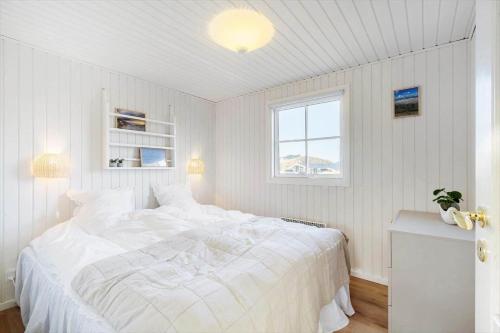 a white bedroom with a large bed and a window at 172-Ringkobing-Magedalen-34 in Ringkøbing