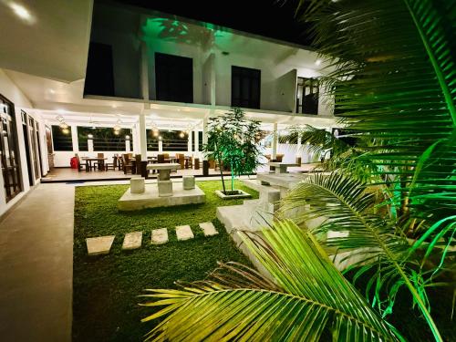 a courtyard with tables and plants in a building at Seven Shape Resort - Talalla in Talalla