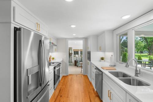 a kitchen with white counters and stainless steel appliances at White Pine Cottage - Close to the Blue Mile in Statesboro