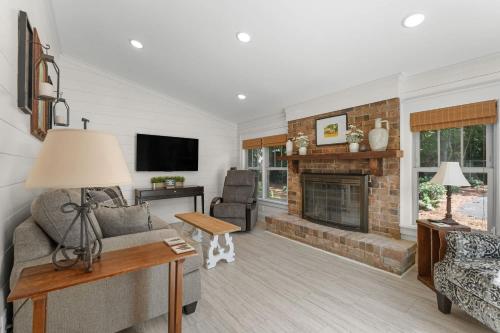 a living room with a couch and a fireplace at White Pine Cottage - Close to the Blue Mile in Statesboro