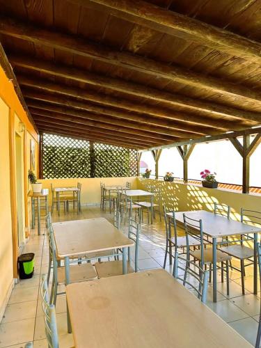 a group of tables and chairs in a cafeteria at Maty's House in Schitul