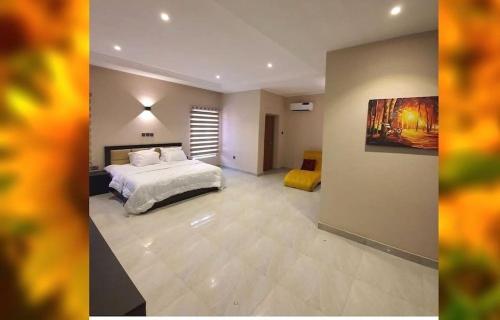 a bedroom with a bed and a painting on the wall at Suris 1 bedroom luxury in Abuja