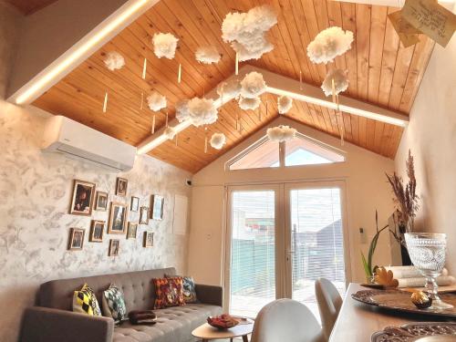 a living room with a ceiling with clouds on it at Harry Potter Magic House in Senec