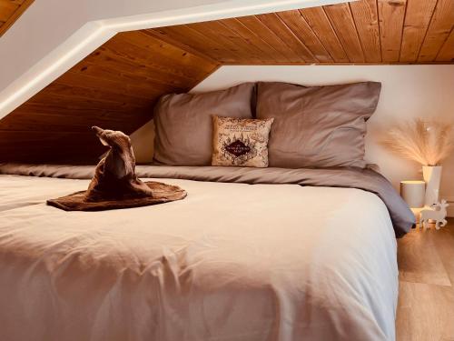 a bedroom with a large bed with a wooden ceiling at Harry Potter Magic House in Senec