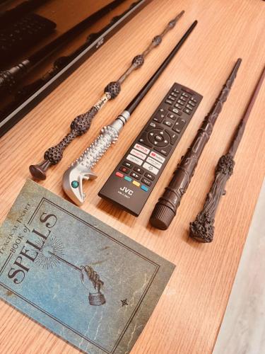 a remote control and a book on a table at Harry Potter Magic House in Senec