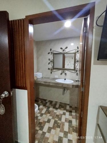 a bathroom with a sink and a mirror at San Francisco Plaza Real in Bucaramanga