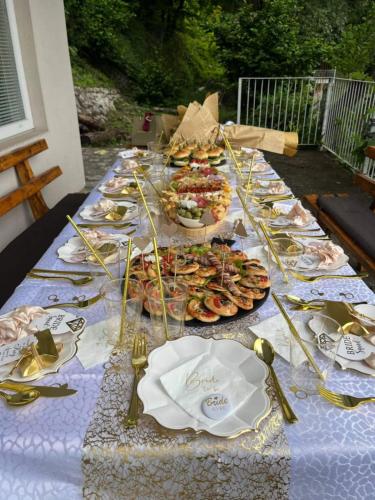 a long table with plates of food on it at Villa Relax Zvornicko Jezero in Zvornik