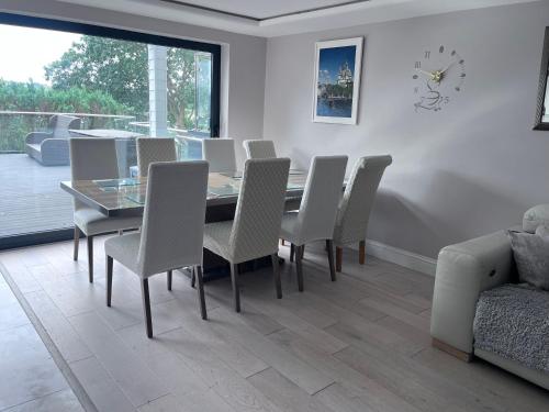a dining room with a table and chairs at Creek view house in Feock