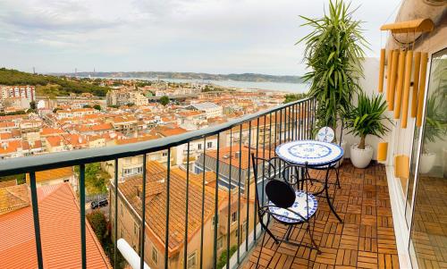 a balcony with two tables and a view of a city at Ideally located with perfect views in Algés