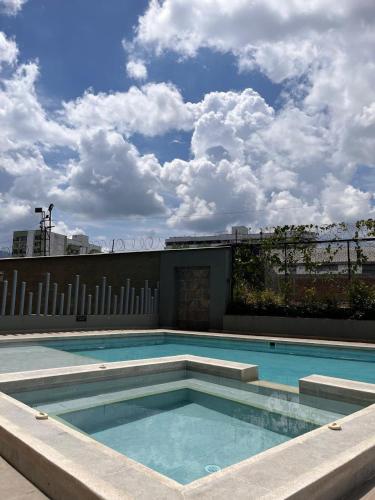 a swimming pool on the roof of a building at Rest and Perfect Location in Dosquebradas