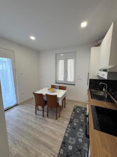 a kitchen and dining room with a table and chairs at House31 in Monfalcone