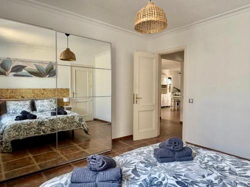 a bedroom with a bed and a large mirror at Villa Morriña by Vulcano Homes in Playa Honda