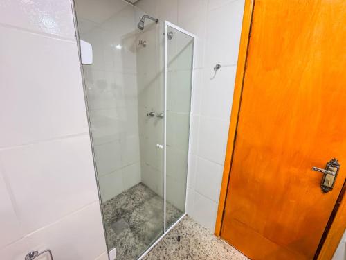 a shower with a glass door in a bathroom at Hotel Nacional Inn Campos do Jordão in Campos do Jordão
