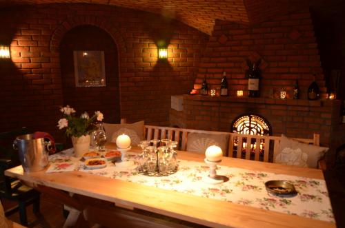 a wooden table with candles on top of it at Impresja - pokoje gościnne na nadbużańskich łąkach in Borsuki