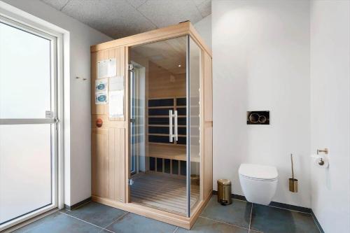 a glass shower in a bathroom with a toilet at 1157-Ringkobing-Frans-Julius-Vej-7 in Ringkøbing