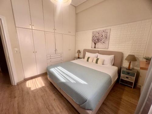a bedroom with a large bed with white cabinets at Luxury seafront house nearby Delphi in Kírra