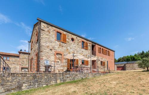 a large brick building with an umbrella in front of it at Corte Liliana in Montegabbione