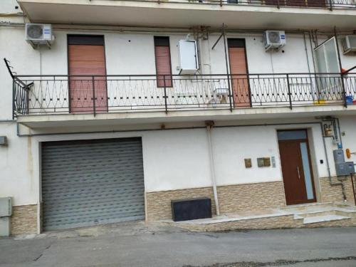 an apartment building with two garage doors and two balconies at PM 16 Alessandro Scarlatti in Marineo